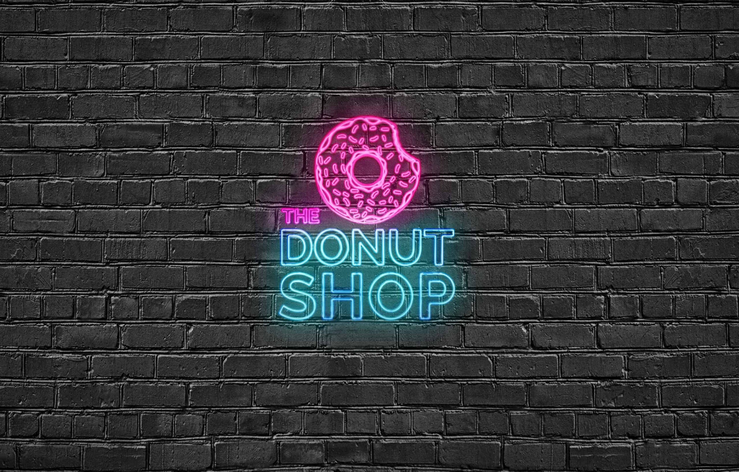 neon sign on brick wall of the donut shop logo